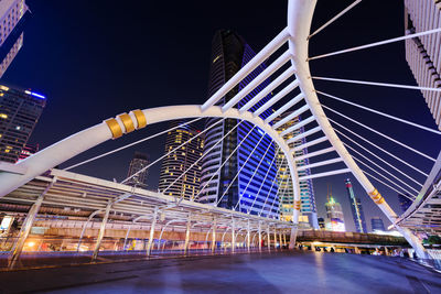 Low angle view of illuminated bridge against sky at night