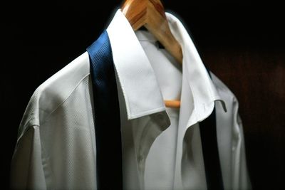 Close-up of clothes hanging against black background