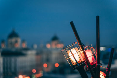 Close-up of illuminated light against sky at dusk