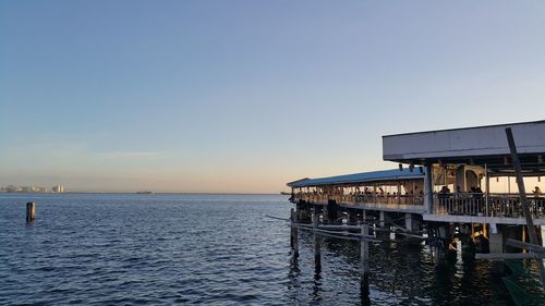 Pier on sea at sunset