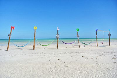 Scenic view of beach against clear blue sky