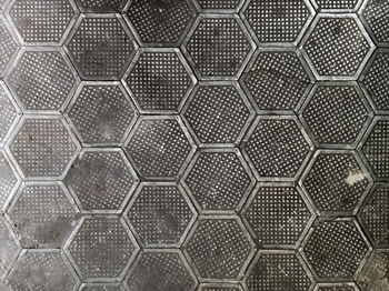 Cast iron hexagonal factory floor texture and background.