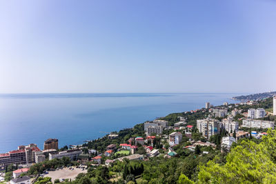 Panoramic view of townscape by sea against clear sky