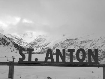 Text on snow covered mountains against sky