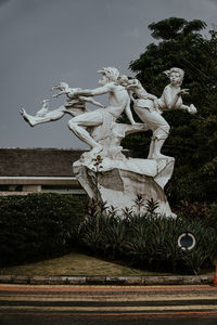 Statue of angel against cloudy sky