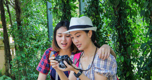 Portrait of a smiling young woman holding plants