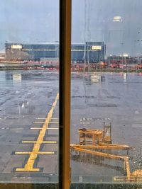 Reflection of city on wet road during rainy season