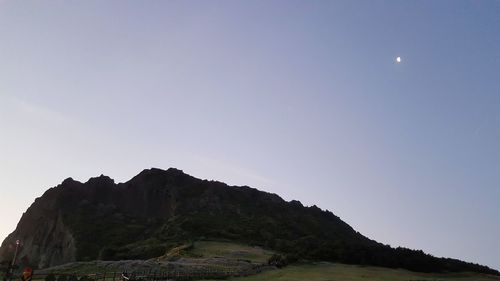 Low angle view of mountains against sky at night