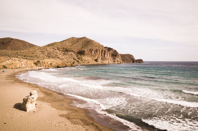 Scenic view of beach by sea against sky