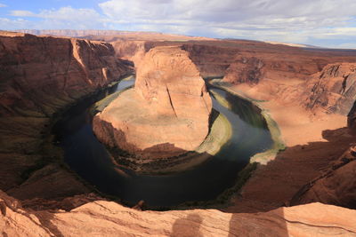 High angle view of horseshoe bend against cloudy sky