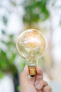 Close-up of hand holding crystal ball