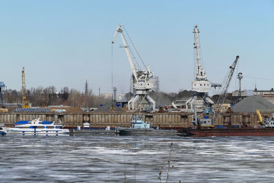 River port. the factory by the river. sand mining. a crane and special equipment for loading sand. 