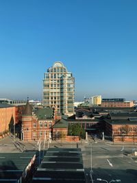 View of modern buildings against clear blue sky