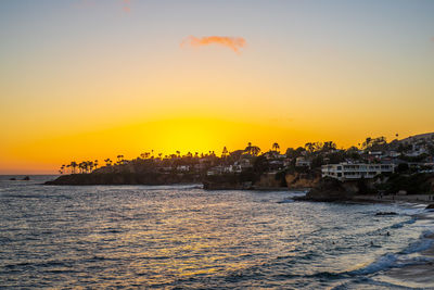 Scenic view of sea against orange sky