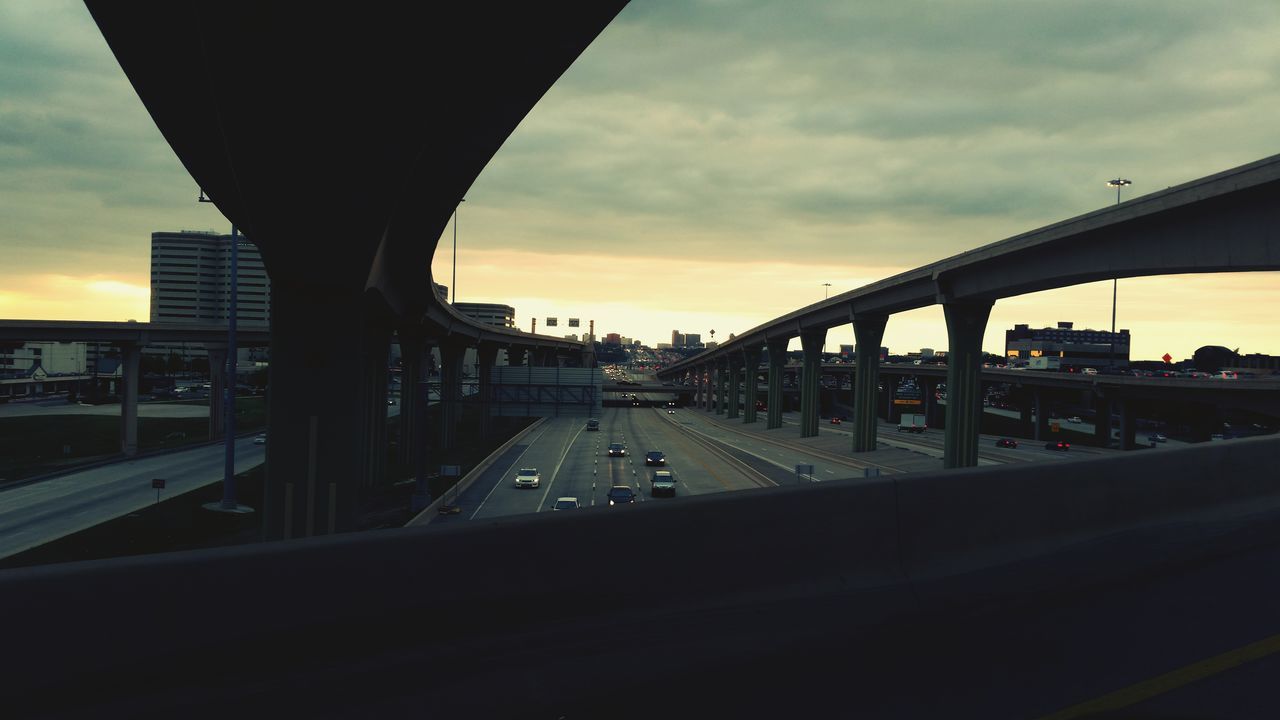 transportation, architecture, built structure, bridge - man made structure, sky, cloud - sky, sunset, connection, mode of transport, public transportation, city, building exterior, engineering, travel, cloud, railroad station, cloudy, car, architectural column, land vehicle