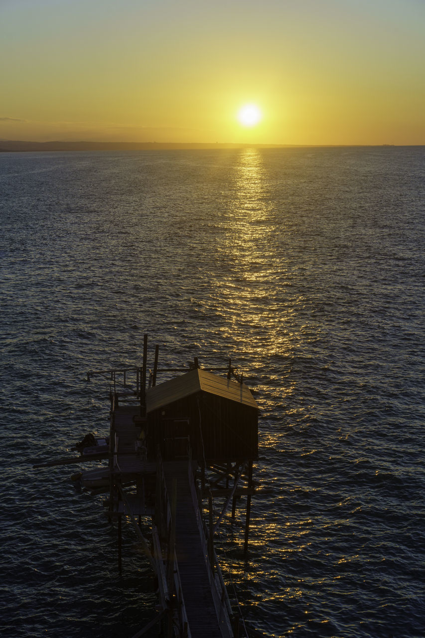 water, sunset, sea, sky, horizon, ocean, beauty in nature, scenics - nature, tranquility, horizon over water, nature, dawn, tranquil scene, coast, sun, reflection, evening, sunlight, no people, idyllic, shore, transportation, outdoors, nautical vessel, rippled, bay, non-urban scene, vehicle, architecture, silhouette