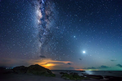 Scenic view of sea against sky at night