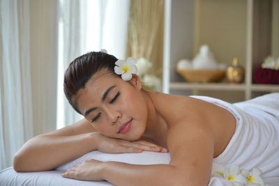Young woman lying with eyes closed