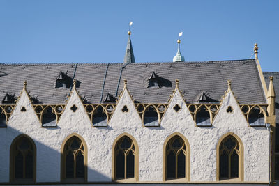 Low angle view of building against clear blue sky