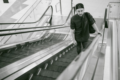 High angle portrait of young man on escalator