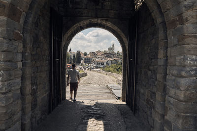 Woman walking in old ruins