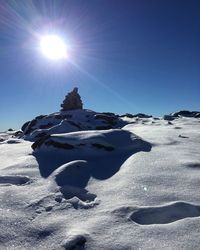 Scenic view of snowcapped mountains against sky on sunny day