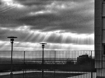 Street light against cloudy sky