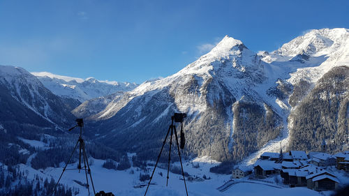 Snow covered mountain against blue sky