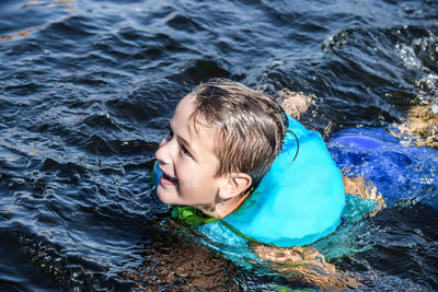 High angle view of smiling boy in sea