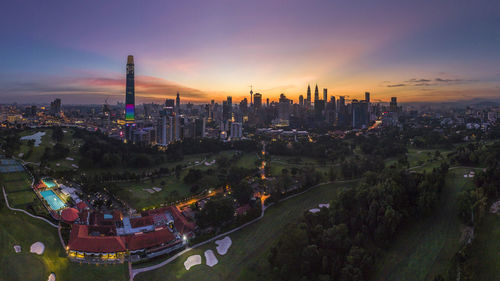 High angle view of illuminated buildings against sky during sunset