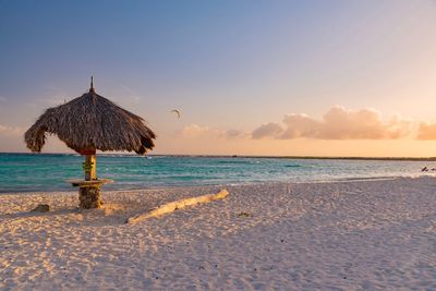 Scenic view of beach against sky during sunset