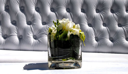 Close-up of white roses in vase on table