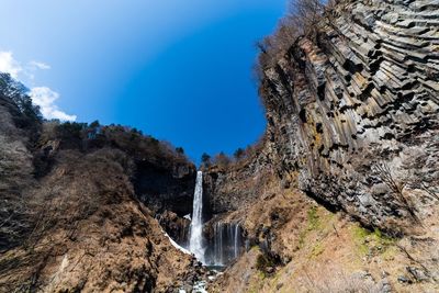 Low angle view of waterfall against sky