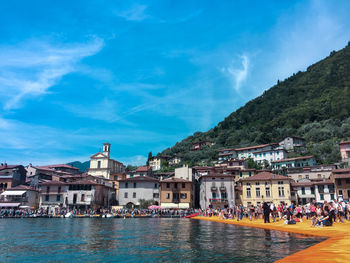 Buildings in city against cloudy sky