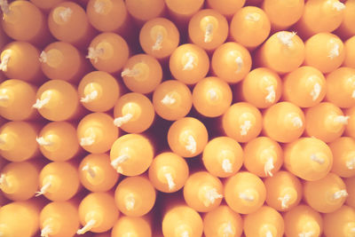 Stack of orange candles create a visual pattern