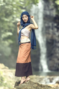 Portrait of smiling young woman standing outdoors