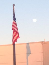 Low angle view of flag against clear sky