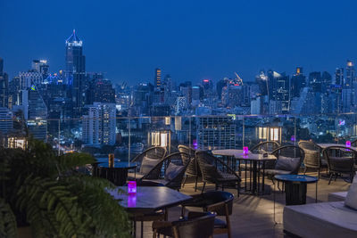 High angle view of illuminated cityscape against sky at night