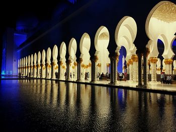 Reflection of illuminated building in water at night