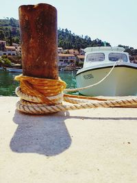 Close-up of ship moored at harbor against clear sky