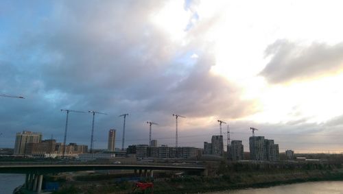 Construction site by buildings against sky