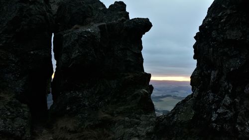 Low angle view of rock formation against sky during sunset