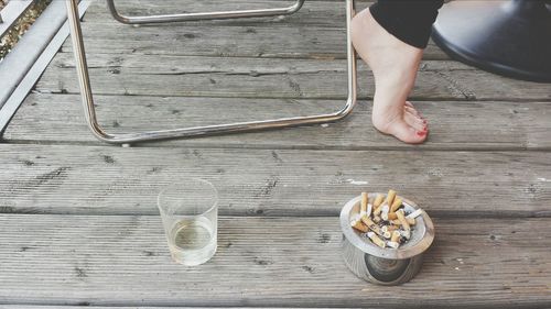 Low section of people standing on wooden table