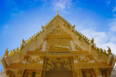 Low angle view of golden thai temple against sky
