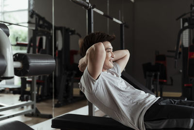Side view of man exercising at gym