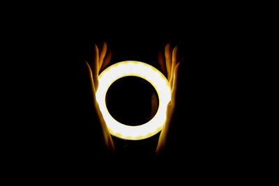 Close-up of illuminated lamp against black background