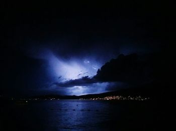 Scenic view of sea against sky at night