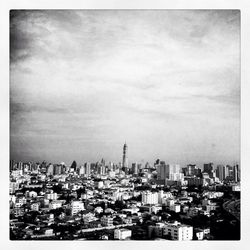 Cityscape against cloudy sky