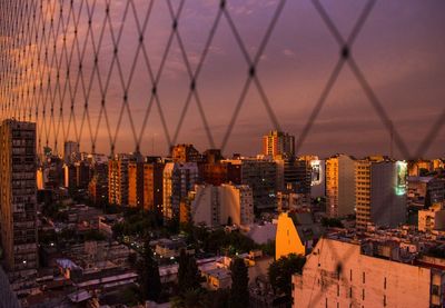 High angle view of buildings in city during sunset