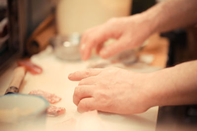 Close-up of hands preparing food